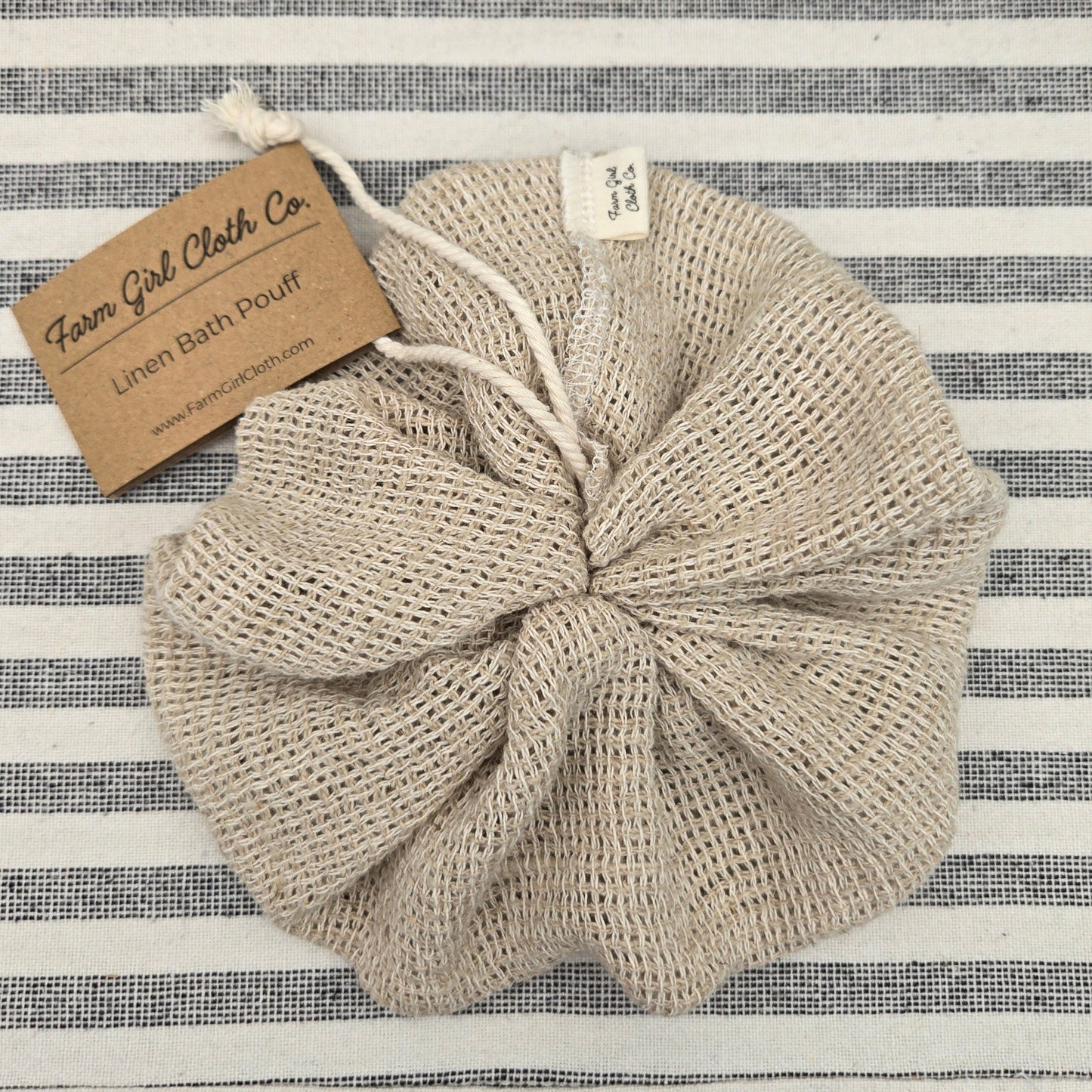 100% linen bath pouff on a striped background