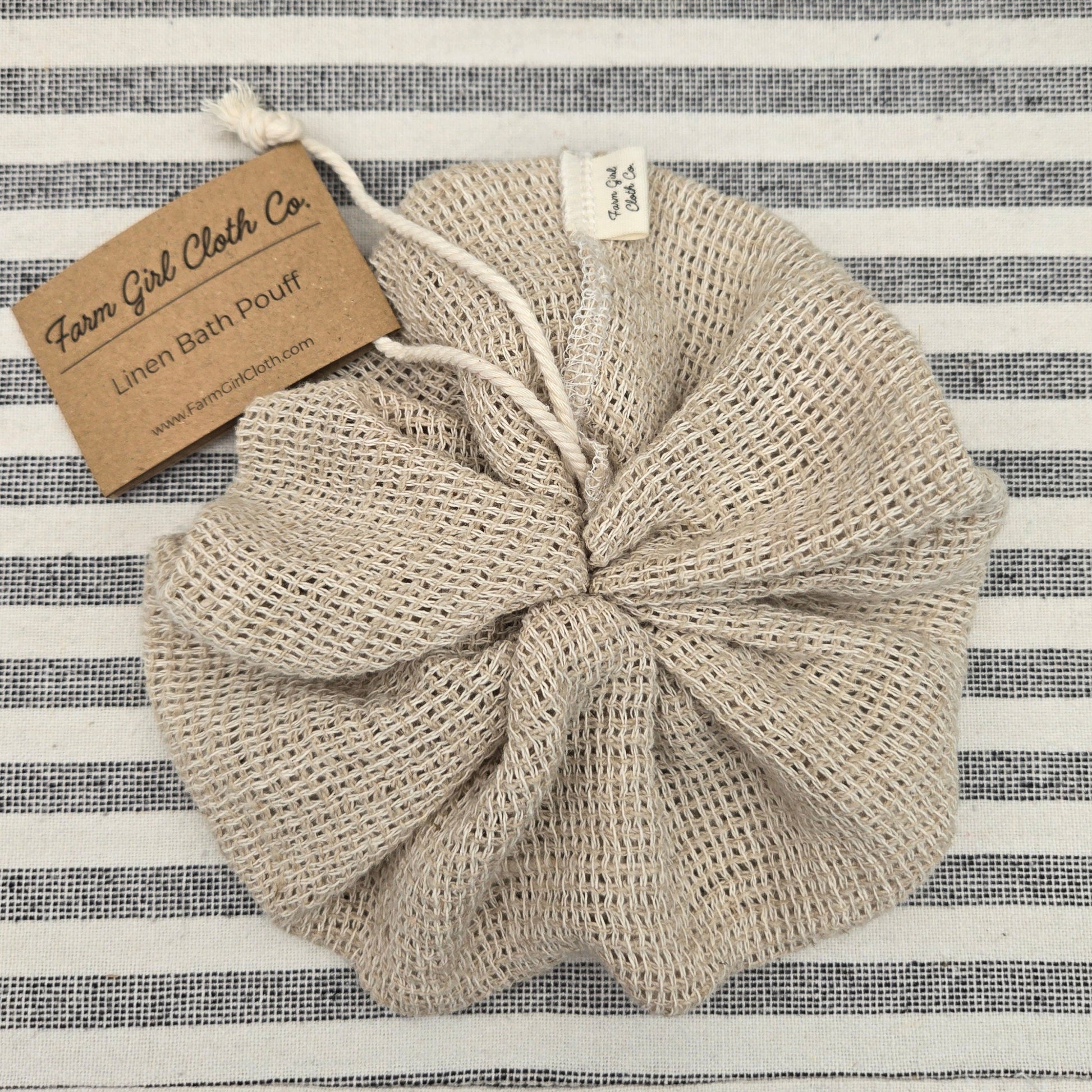 100% linen bath pouff on a striped background