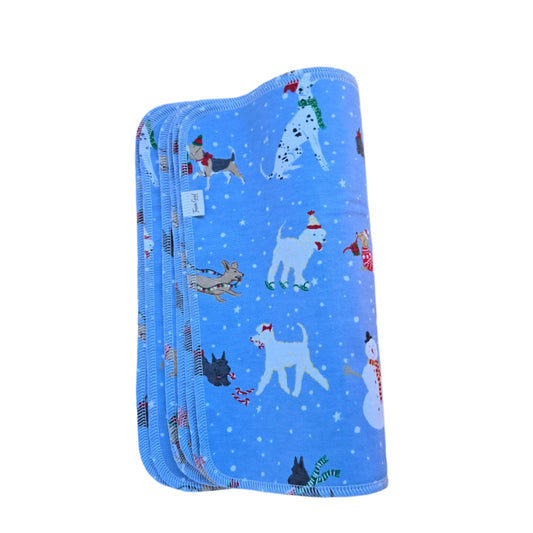 A stack of blue paperless towels with a winter dogs pattern, featuring various cartoon dogs and snowflakes.
