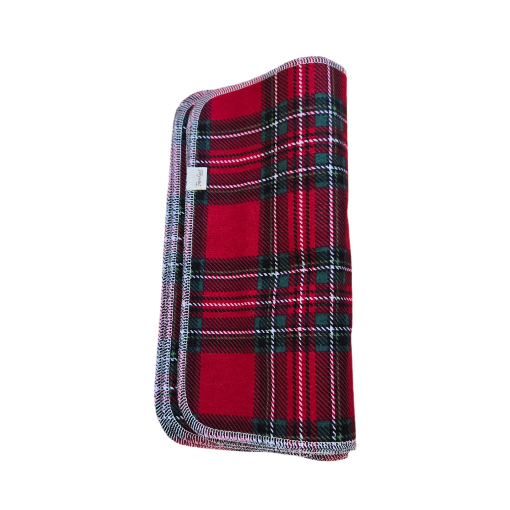 A red and green plaid cotton towel on a wooden surface.